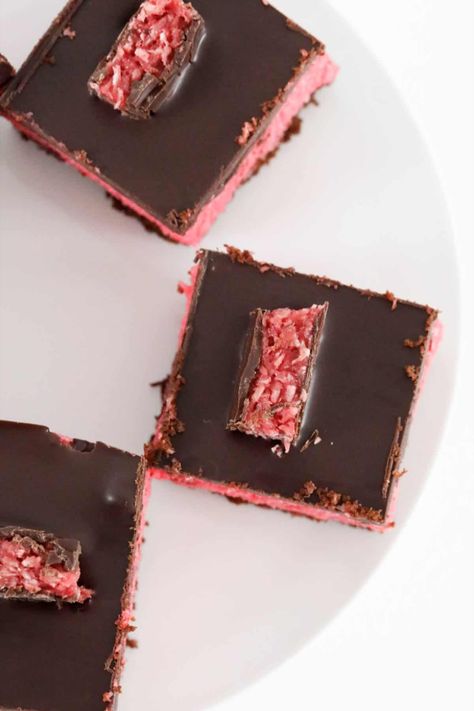 A colourful slice with a chocolate biscut base, a pink coconut and cherry centre, then topped with a layer of chocolate and slices of Cherry Ripe Bars Cherry Ripe Slice, Chocolate Ripple Biscuits, No Bake Slices, Crunchy Chocolate, Chocolate Slice, Glace Cherries, Slices Recipes, Baking Tins, Chocolate Cherry