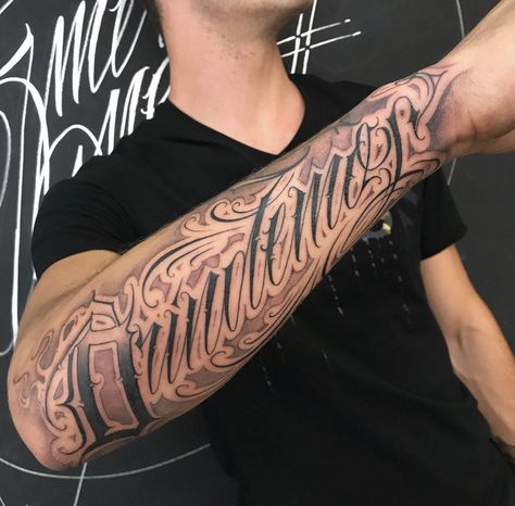 Old English Forearm Tattoo, Bicep Script Tattoo Men, Forearm Lettering Tattoo Men, Cursive Forearm Tattoo Men, Cursive Name Tattoo On Arm, Name On Arm Tattoo Man, Men’s Script Tattoos, Bold Letter Tattoo, Forearm Tattoos Words Lettering