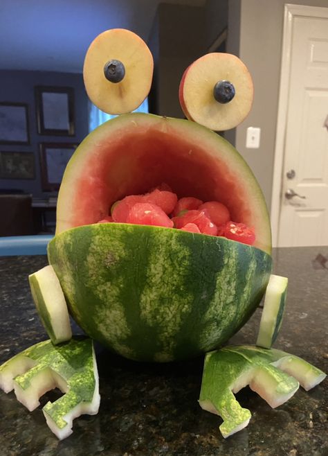 Frog carved from watermelon sitting on black granite countertop apple blueberry eyes Watermelon Frog, Watermelon Carving, Watermelon Party, Healthy Treat, Fruit Carving, Party Celebration, Summer Parties, Healthy Treats, Celebration Party