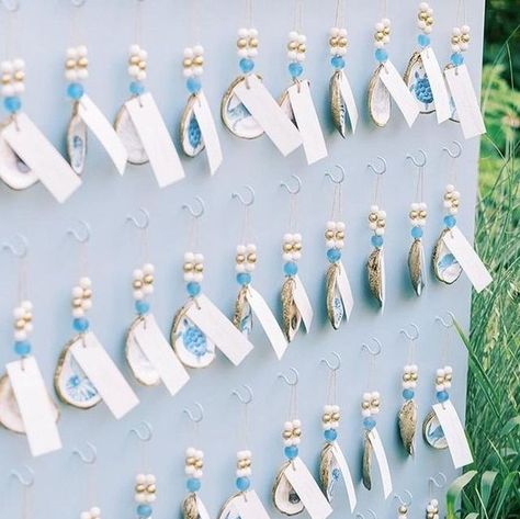 Grit & Grace Studio on Instagram: "⁠ How stunning is this seating chart wall that not only assigned seats but also gifted guests with our Gilded Seascapes collection from @printedhues?⁠ ⁠ When Natalie from @whimevents reached out to us in July, we were beyond excited to contribute to this bride's special celebration.⁠ ⁠ Knowing that our oyster ornaments would be a keepsake for guests to remember the day made us truly honored to be involved.⁠ ⁠ Interested in bulk pricing? Send us a DM or email marketing@gritandgracestudio.com for more details!⁠ ⁠ Planning, Design & floral: @whimevents⁠ Tent: @greenwichtentco⁠ Catering: @katestable⁠ Photo: @perryaile⁠ Video: mapleloft studios⁠ Day of Stationery: @coralpheasant⁠ Rentals: @form_creativeservices @kadeemarentals @laaffitto @peakeventservices⁠ Li Wedding Seating Chart Oysters, Seashell Seating Chart, Beach Wedding Seating Chart Ideas, Oyster Shell Seating Chart, Shell Seating Chart, Oyster Seating Chart, Seating Chart Wall, Grit Grace, Beach Activity