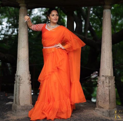 anasuya bharadwaj in an orange pre draped saree by kowshiki Orange Organza Saree, Pre Draped Saree, Saree Belt, Anasuya Bharadwaj, Saree With Belt, Draped Saree, Orange Saree, Blush On Cheeks, Ruffle Saree