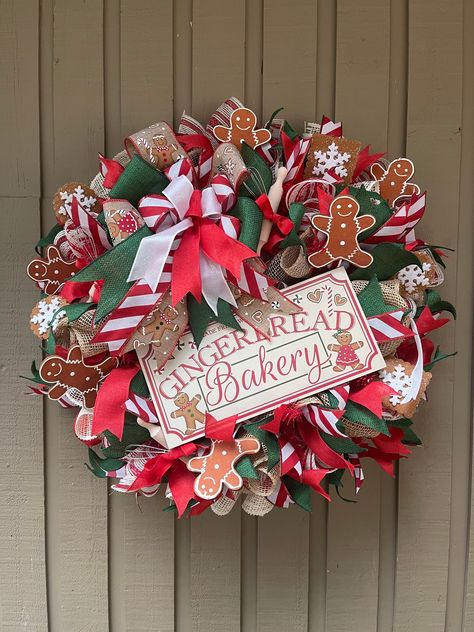 BLACK FRIDAY SALE THRU 11/30 - Use code JOLLY20 for 20% off Meet Gretel! Welcome your guests with this cozy and cute front door wreath.  This wreath is made with a  red and white striped and tan poly burlap mesh.  It's finished with coordinating wired ribbon tails and bow, adorable gingerbread cookies, miniature whisks and rolling pins, and a cute gingerbread bakery sign.  It measures approximately 24" (ribbon tip to ribbon tip) wide and 8-10" deep. This wreath is already made and ready to ship. This wreath can be placed outdoors, but I do recommend it be placed under a covered porch.  Please secure the wreath from the elements. The mesh is waterproof, but the ribbon and embellishments are not.  As with any material, if placed in direct sunlight, your wreath will fade over the years. Wreat Cute Front Door, Christmas Reef, Gingerbread Bakery, Ribbon Wreath Christmas, Gingerbread Wreath, Bakery Sign, Deco Mesh Christmas Wreaths, Christmas Mesh Wreaths, Flower Gift Ideas