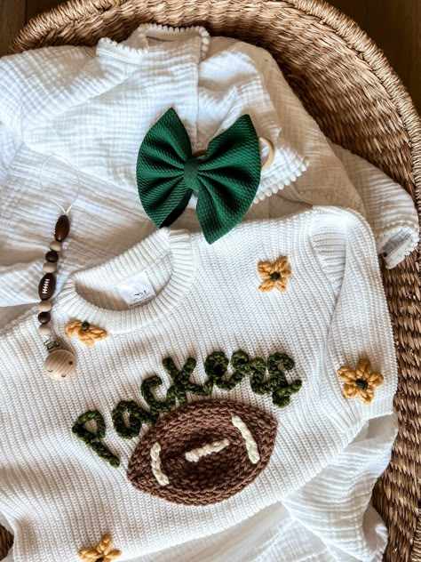 SWEATER IS OVERSIZED. Size down for a true oversized fit Personalized Hand-Embroidered Baby and Toddler Sweaters for all NFL teams Arizona Cardinals Atlanta Falcons Baltimore Ravens Buffalo Bills Carolina Panthers Chicago Bears Cincinnati Bengals Cleveland Browns Dallas Cowboys Denver Broncos Detroit Lions Green Bay Packers Houston Texans Indianapolis Colts Jacksonville Jaguars Kansas City Chiefs Las Vegas Raiders Los Angeles Chargers Los Angeles Rams Miami Dolphins Minnesota Vikings New England Machine Embroidered Sweatshirt, Things To Make With Vinyl, Embroidered Baby Announcement, Little Boy Embroidery Ideas, Newborn Embroidery Ideas, Baby Clothes Embroidery, Embroidered Baby Gifts, Gifts For Nephew, Baby Name Sweater