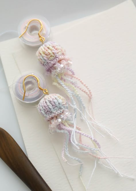 FREE SHIPPING ON $35.00 These  beautiful  jellyfish micro Crochet earrings are handmade.  I hope you can enjoy it. It would also be a perfect gift for her. Material: 14K gold plated， micro crochet thread These items are all handmade by me.  Maybe each one will be slightly different from the picture.  But each one is crocheted with love.  I hope you will like it. this are handcrafted and very delicate. Please make sure do not to get wet .Please do not wash or wear in the shower . Please avoid fire or high heat, constant grinding or friction. Please avoid contact with sharp objects. If you have any problem, feel free to contact me. Cute Crochet Earrings, Micro Crochet Earrings, Silly Earrings, Beautiful Jellyfish, Jellyfish Jewelry, Crochet Jellyfish, Crochet Lace Shawl, Crocheted Jellyfish, Earrings Crochet