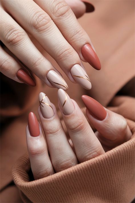 Embrace the season with these chic fall nail ideas that exude a sophisticated yet understated vibe. This Autumn simple design features a warm terracotta base adorned with delicate leaf patterns in muted gold and rust. Perfect for any occasion, these nails capture the essence of fall while remaining effortlessly stylish. Elevate your nail game this autumn with this stunning look! #FallNailIdeas #AutumnNails #NailArt #SeasonalStyle Nails To Match Rust Color Dress, Terracota Nails Ideas, Rust Color Nails Designs, Rust Nail Color, Terracotta Nails Designs, Rust Nails Design, Earth Tone Nails Designs, Simple Fall Nails Autumn, Simple Fall Nail Ideas