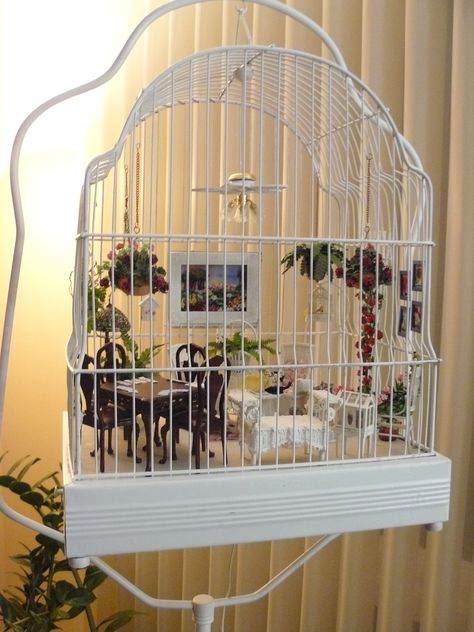 Patty's porch in a bird cage ~ My customer, Patty, sent me a message asking if I could make a small birdhouse to hang on a wall - or in her case, the bars of this bird cage. It took two designs to get it the right depth and size, but in the end, she was very happy with it. I am just so impressed with Patty's project. It's a unique idea, and it turned out beautifully. miniaturesfromavalon Bird Cage Makeover, Birdcage Diorama, Birdcage Dollhouse, Caged Fairy, Miniature Porch, Birdcage Ideas, Hanging Bird Cage, Fairy Room, Room Boxes