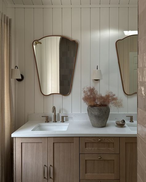 Cottage Living in the City | The existing bathroom had tall ceilings and a beautiful skylight but lacked storage and functionality. For the design, we decided to clad all the walls and ceiling in shiplap, adding to the height and volume of the bathroom! Due to the tight project timeline, we sourced a premade vanity but upgraded it with beautiful antique brass hardware and fixtures. We added intricate and dreamy details like curved mirrors, vintage sconces with fabric shades, and full-length... Tall Bathroom Ceiling, Horizontal Shiplap Bathroom, Shiplap Ceiling Bathroom, Full Length Bathroom Mirror, Cottage Bathroom Vanity, Slanted Ceiling Bathroom, Shiplap Wainscoting, Flood Proof House, Bathroom Shiplap