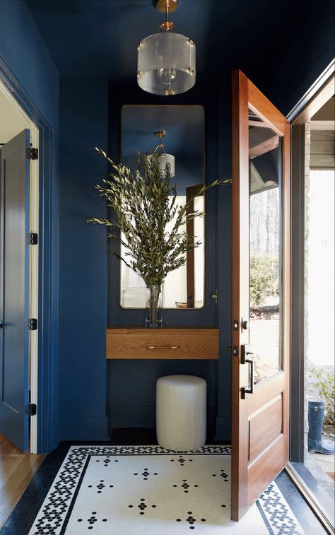 This entry makes a statement with a retro tile rug and beautiful blue walls . #interiordesign #tile #tiledesign #entryway Foyer Tile Ideas, Entrance Hall Decor, Foyer Wall, Entryway Tile, Front Hallway, Entry Tile, Art Deco Kitchen, Cool Room Designs, Tiled Hallway