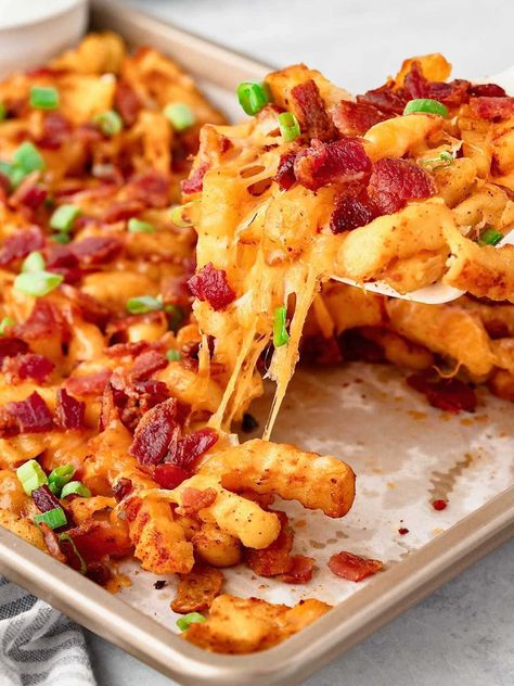 Loaded French Fries make the ultimate comfort food snack! Think crispy fries piled high with melted cheese, smoky bacon, a dollop of sour cream, and a sprinkle of green onions. One bite and you’ll see why these cheesy fries are the star of Game Day! Cheese Fries With Bacon, Stuffed French Fries, Halloween French Fries, Loaded French Fries, Loaded Fries Recipe, Crinkle Fries, Cheesy Fries, Crispy Fries, Themed Dinner