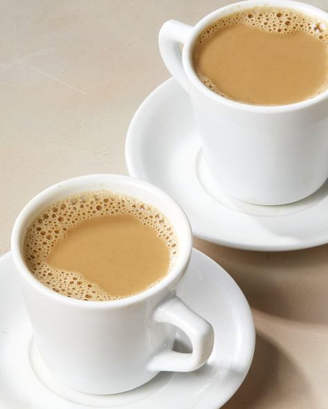 Angled shot of two white tea cups and saucers full of hot milk tea, on a beige surface. Hot Milk Tea, Deviled Egg Dip, 2 Cup Tea, Orange Pekoe Tea, Leftover Milk, Desi Recipes, Gluten Free Milk, Milk Tea Recipes, Turmeric Tea