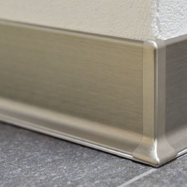 A New Type of Baseboard for Tiled Floors | schluter.com Home Baseboard Ideas, Baseboard Alternative, Baseboard Alternative Ideas, Garage Baseboard Ideas, Baseboard Replacement, Bathroom Baseboard Ideas, Flush Skirting, Metal Baseboard, Skirting Detail