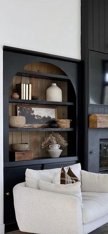 Fireplace Built Ins Black, Black Bookcases Around Fireplace, Bookcase Next To Fireplace Freestanding, Two Tone Built Ins Bookshelves, Modern Tudor House Interior, Modern Built In Bookcase, Wall Of Shelves Living Room, Fireplace With Arched Built Ins, Bookshelves Beside Fireplace