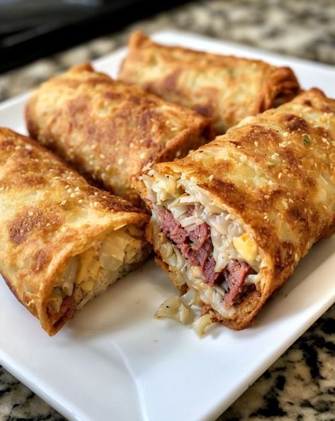 Crispy Reuben Egg Rolls: Flavor-packed twist on a classic! Perfect for parties, loaded with corned beef, sauerkraut, and Swiss cheese. #PartySnacks #FusionFood #ReubenTwist Corn Beef Egg Rolls, Rueben Egg Rolls, Beef Egg Rolls, Reuben Egg Rolls, Raspberry Thumbprint Cookies, Cooking Corned Beef, Crispy Egg, Russian Dressing, Potato Fritters