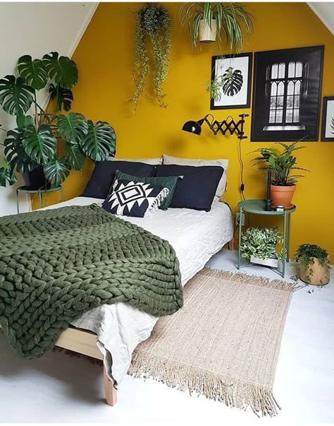 a mustard accent wall and touches of dark green and potted plants make up a bold boho space Mustard Yellow Bedrooms, Millenial Pink, Yellow Bedroom, Yellow Walls, Gen Z, Home Design Decor, Home Fashion, Green Plants, New Room