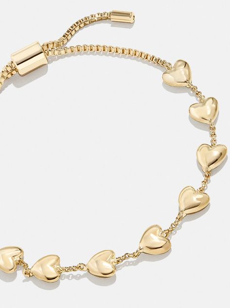 The Brittany Bracelet is the perfect way to add a subtle dose of affection to your curated wrist stack. This bracelet features petite heart adornments with chic negative space in between. Better yet, it's finished off with a pull-tie closure, meaning you'll always get the perfect fit. Gold Heart Bracelet For Women, Gold Stacking Bracelets, Cute Gold Jewelry, Gold Jewelry Bracelets, Gold Bracelet Stack, Wrist Stack, Gold Bracelets Stacked, Bauble Bar, Gold Heart Bracelet