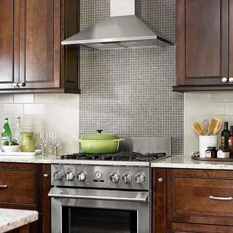 Contrasting Tile BacksplashTiny glass mosaic tiles form the range backsplash in this chic, old-meets-new kitchen. Larger light gray subway tiles run horizontally above the countertop and allow the range backsplash to be the kitchen's standout surface. Simple Backsplash, Stainless Steel Kitchen Backsplash, Range Backsplash, Entry Floor, Range Tile, Moms Kitchen, Patterned Tile Backsplash, Stainless Steel Backsplash, Stove Backsplash