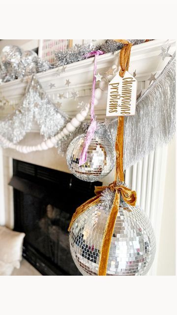 Kelsey Klos on Instagram: "Swap your stockings for disco balls, frame festive wrapping paper, display all the snowy details and add tinsel! 🪩🥂✨" White Disco Ball Aesthetic, Christmas Decor Display Ideas, Disco Ball Holiday Decor, Disco Ball Mantle, Disco Ball Christmas Tree Ideas, Disco Ball Tree Christmas, Disco Christmas Aesthetic, Disco Ball Display, Disco Ball Window Display