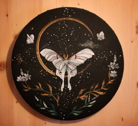 I loved painting this round canvas. I wanted it to have an etheral vibe so I added stars, crescent moon and Luna Moths. I used acrylics. Diameter: 30 cm Black Round Canvas Art, Things To Paint On A Round Canvas, Luna Moth Painting Acrylic, Paintings On Records, Round Canvas Ideas, Witchy Art Painting, Painting Ideas On Circle Canvas, Moth Painting Acrylic, Round Painting Ideas