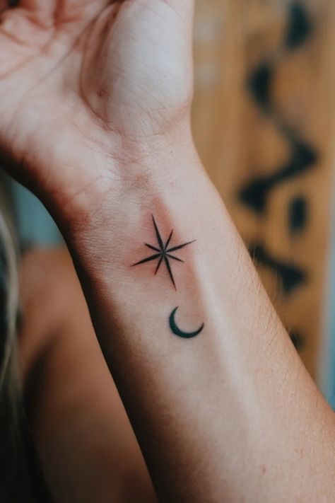 Minimalist tattoo of an eight-pointed star and a crescent moon on an inner forearm. Star Memorial Tattoo, Star Wrist Tattoos For Women, Starry Tattoo, Star Wrist Tattoo, Star Tattoo On Wrist, North Star Tattoos, Small Wrist Tattoo, Wrist Tattoo Ideas, Feminine Mystique