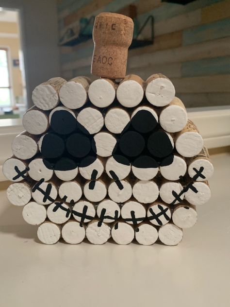 A bit more than 40 corks painted white, hot glued into a pumpkin shape, then details painted over top in black. Topped with a champagne cork. Holiday Wood Projects Diy, Easy Cork Crafts, Wine Cork Turkey, Cork Crafts Halloween, Corks Crafts, Diy Cork Crafts, Wine Corks Crafts, Halloween Wine Cork Crafts, Wine Cork Halloween Crafts