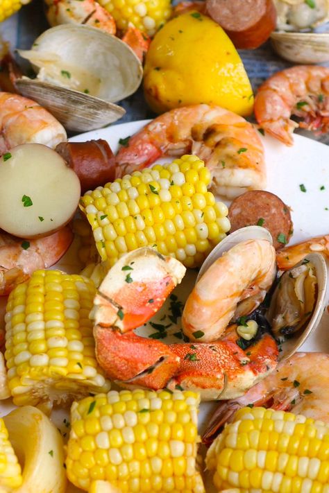 No false promise: this is a seriously impressive Seafood Boil that is made entirely in ONE large pot in 30 minutes! This Southern crowd-pleaser includes crabs, clams, shrimp, sausages, potatoes, and sweet corn, all boiled together in a flavorful Cajun broth! Serve it with a popular Seafood Boil Sauce for the most satisfying meal! Crawfish Boil Recipe, Seafood Boil Sauce, Seafood Boils, Cajun Seafood Boil, Easy Cajun, Cajun Seafood, Seafood Boil Recipes, Shrimp Sausage, Boiled Food