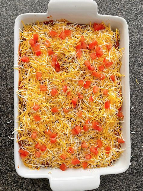 Craving Taco Bell's Mexican Pizza but want to feed a crowd? Try this easy Taco Bell Mexican Pizza Casserole! Layered with seasoned ground beef, refried beans, cheese, and crunchy tostada shells, it's the perfect family dinner or party dish. Customize it with your favorite toppings like diced tomatoes, green onions, and sour cream for even more flavor. Save this recipe for your next Taco Tuesday! Mexican Pizza With Tostada Shells, Mexican Pizza Casserole, Fast Food Icon, Tostada Shells, Taco Bell Mexican Pizza, Mexican Pizza, Ground Sirloin, Food Icon, Pizza Casserole