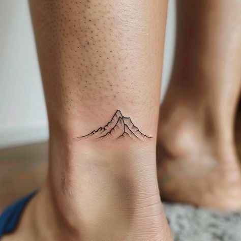 Embody the spirit of adventure with this minimalist mountain tattoo, etched gracefully on the inner ankle— a symbol of overcoming challenges and reaching new heights. Ideal for those who cherish simplicity and monumental life journeys, this tattoo inspires us to embrace the peaks and valleys of life. Let this work of art remind you of your personal growth and the landscapes yet to be explored. Save and follow for more inspirational ink ideas. #MinimalistTattoo #MountainInk #AdventureSymbol #PersonalGrowth # Unalome Mountain Tattoo, Minimalist Mountain Tattoo, Adventure Symbol, Minimalist Mountain, Peaks And Valleys, Landscape Tattoo, Overcoming Challenges, Mountain Tattoo, Ink Ideas