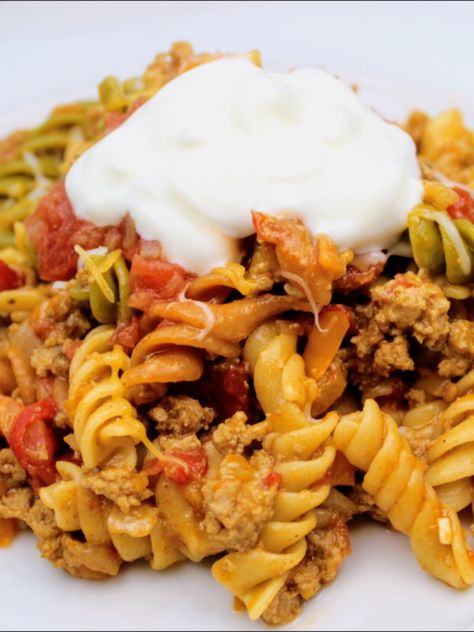 Spicy taco seasoned ground turkey with Rotel, Sauteed onion and pepper tossed with tri-colored rotini pasta and topped with cheese, salsa, and sour cream. Tri Color Pasta Recipes Dinners, Rotini Ground Beef Recipes, Pasta With Rotel, Tri Color Pasta Recipes, Tri Colored Pasta Recipes, Creamy Rotel Pasta With Ground Beef, Tri Color Rotini Pasta Recipes Dinner, Tri Color Rotini Pasta Recipes, Tri Colored Rotini Pasta Recipes