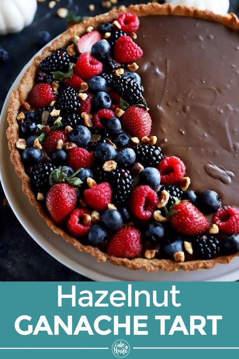 A Chocolate Tart with Hazelnut Crust is the elegant dessert that is deceptively simple to make. The dark chocolate ganache filling is creamy and rich, topping a toasted hazelnut pastry. The addition of tart berries on top makes for a killer combo for any gathering! | cakenknife.com #easyrecipe #darkchocolateganache #decoration #thanksgiving #holiday #dessert Hazelnut Crust, Hot Fudge Cake, Hot Chocolate Fudge, Ganache Filling, Chocolate Ganache Filling, Dark Chocolate Ganache, Single Serve Desserts, Dessert Spread, Trifle Desserts