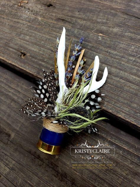 Custom Half Navy Blue Shotgun Shell Boutonnieres with Antlers, Lavender, Guinea Hen Feathers & Thistle 💙
WWW.KRISTYCLAIRE.ETSY.COM 
www.kristyclairefloraldesign.com 
#weddingboutonniere #weddingdecor #wedding #weddingcorsage #weddingparty #weddingdesign #newzealand #shotgun #shotgunshells #antlers #antlerdecor #antlerart #hunting #unique #lavender #thistle #polkadots #guineafowl #newzealandlife #newzealandphotography #thankyou #fauxantlers #mini Fishhook Boutonniere, Shotgun Boutineers, Wedding Decor With Antlers, Western Wedding Boutonniere, Hunting Boutonniere, Shotgun Shell Boutineer, Shotgun Shell Boutonniere Diy, Hunting Themed Wedding, Antler Boutonniere