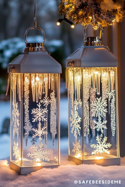 Two frosted glass lanterns with intricate snowflake designs, icicle patterns, and glowing LED lights. They sit on a snowy surface, creating a warm and magical winter ambiance. *We may earn a small commission from your purchase. Winter Lantern Ideas, Lantern Filler Ideas, Snowflake Lantern, Winter Lantern, Acrylic Christmas Ornaments, Christmas Snowflakes Decorations, Frosted Window, Snowflake Sticker, Icicle Ornaments