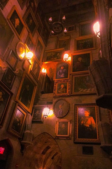 Framed art with Harry Potter Hogwarts characters. Lanterns on the wall. 16th century oil painting of various portraits Cozy Harry Potter Room, Harry Potter Oil Painting, Harry Potter Themed Living Room, Harry Potter Gallery Wall, Wizard Room Aesthetic, Painting Portrait Ideas, Harry Potter Frame, Harry Potter Room Aesthetic, Shrine Aesthetic