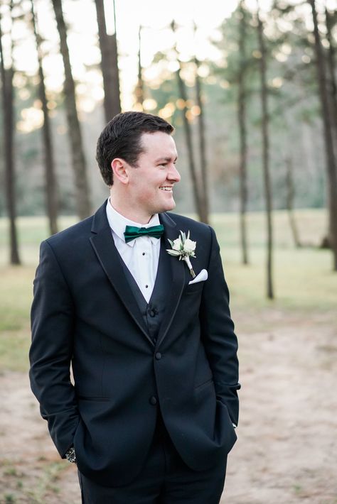 | groom in a black tux | winter groom ideas | groom in black tux with dark green bow tie | christmas wedding ideas | classy winter wedding ideas | winter wedding style | groom accessories | groom's look | groom in black | classy groom | classy wedding | photo taken at THE SPRINGS Event Venue. follow this pin to our website for more information, or to book your free tour! SPRINGS location:  Pine Hall in Lake Conroe, TX photographer:  Caitlin Rose Photography #groom #winterwedding #weddingstyle Black Tux With Emerald Green Bow Tie, Black Tux With Green Bow Tie, Black Suit With Green Bow Tie, Black Tux Green Bow Tie, Black Tux Green Tie, Black Suit Green Bow Tie, Black Tux With Green Tie, Debut Court, Winter Groom