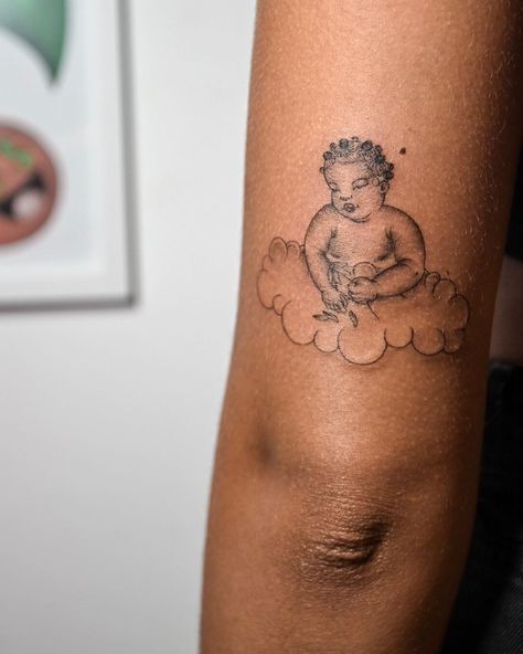 Cake on Instagram: “Chunky Bantu Cherub Baby & a lil “yeerrr” on raffle winner @word.itsmendes . Girlsonlyny.com” Afro Cherub Tattoo, Cherub On Cloud Tattoo, Cherub Rib Tattoo, Cherub Praying Tattoo, Unique Cherub Tattoo, Cherub Baby, Dark Skin Tattoo, Cherub Tattoo, Knot Tattoo