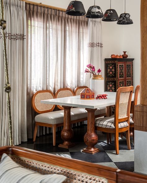 The dining space; where the entire family gets together during mealtimes ❤️  The dining table is a stone top furniture with massive pillar legs that only do justice to the scale of the home 😍 We custom created these pillars to vibe with the rest of the home ❤️  The chairs and the bench were made in house too and we conceptualised them with cane for the clients love of it ❤️  We again chose hand painted pendants to hang above the table - a perfect fit to the space that also sported the gorgeous hand painted vintage crockery cabinet ❤️  Attention also to the curtains where we block printed the upper border to add to the authentic ethnic charm 🥰   #studioipsa #diningroom #diningroomdesign #diningroomdecor #diningtabledesign #diningtable #diningchairs #vintage Painted Pendants, Crockery Cabinet, Starter House, Hand Painted Pendant, Vintage Crockery, The Curtains, Cane Chair, Top Furniture, Indian Kitchen