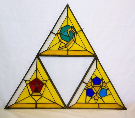 This triforce inspired piece is made out of 90 pieces of glass all carefully cut, shaped and assembled together. Its made out of 10 different kinds of glass. The triforce has a leaded outline, for strenght and a nice and smooth finish, and comes with 2 little hooks so it can be hung in front of a window. The size is about 16 inches wide and 15 inches high. Please note that all pieces are made to order so keep in mind to order them in time. As soon as the order payment is confirmed the i... Legend Of Zelda Art, Stained Glass Tattoo, Zelda Tattoo, Diy Christmas Presents, Stained Glass Diy, Zelda Art, Ocarina Of Time, Stained Glass Projects, Stained Glass Patterns