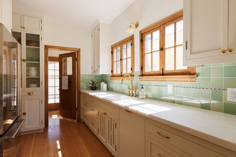 Photo 6 of 10 in This Restored 1920s L.A. Home Is Packed With Delightful Nooks & Crannies - Dwell Green Kitchen Backsplash, 1920s Home, Douglas Fir Flooring, Natural Stone Counter, Inset Cabinetry, Writing Corner, Antique Light Fixtures, Los Angeles Real Estate, Custom Built Ins