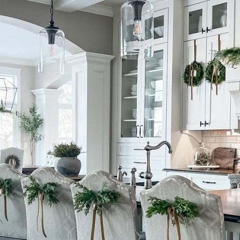 Sandra Herzog | Decor Finds & Design Tips on Instagram: "HOLIDAY INSPO: Chair Swags I haven’t decorated my kitchen or dining room chairs yet, but I’ll be doing something similar to this in my kitchen. It’s a simple, pretty look and easy to do. Supplies needed… greenery picks, small bells, velvet ribbon and a little floral wire. I use bent safety pins on fabric and command hooks on wood for attaching. PAINT: SW Anew Gray | SW Alabaster ⠀⠀⠀⠀⠀⠀⠀⠀⠀ ⠀⠀⠀⠀⠀⠀⠀⠀⠀ HOW TO SHOP: ⭐️ Comment SHOP and links will be sent to your IG messages. ⭐️ Direct link to my @shop.LTK. ⤵️ https://liketk.it/4ngTn ⭐️ Click on the LTK link in my bio. . Holiday home, holiday decor, Christmas decor, home interiors, home styling, affordable decor, home decor, Christmas decorating, holiday 2023, holiday decorating, holi Sw Anew Gray, Ig Messages, Sw Alabaster, Chair Swag, Fun Holiday Food, Anew Gray, Christmas Chair, Holiday Inspo, Christmas Kitchen Decor