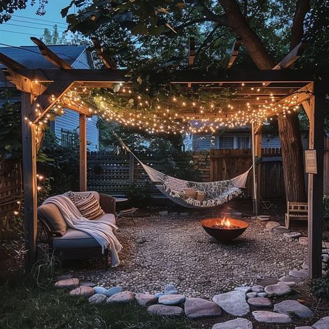 Serene backyard oasis with pergola, hammock, and fire pit surrounded by lush greenery Backyard Landscaping Hammock, Backyard Hammock Oasis, Backyard With Hammock, Hammock Pergola, Cozy Outdoor Spaces, Pergola Hammock, Serene Backyard, Cozy Hammock, Cottage Backyard