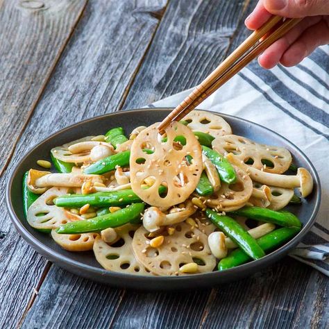 A crunchy preparation of lotus root slices tossed in ginger garlic, green onions and seasoning.Crispy Lotus Stem is an Asian style stir-fry made with lotus stem or roots. This lotus stem stir-fry is definitely better than any Chinese takeout you are planning for dinner. Load it with your favorite vegetables/greens and you are all set for the crunchy stir-fry meal. Fried Lotus Root, Lotus Root Recipe, Cooking Japanese, Ginger Recipe, Pine Nut Recipes, Happy Tuesday Everyone, Garlic And Ginger, Lotus Root, Chinese Takeout