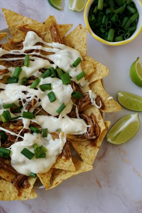 These cheesy pulled pork nachos are piled high with tortilla chips, loaded with sweet pulled pork and LOTS of homemade queso blanco and crisp green onions. Load them up with your favorite toppings and you won’t be able to shove them into your mouth fast enough! ;) Pork Nachos With Queso, Homemade Queso Blanco, Sweet Pulled Pork, Queso Nachos, Pulled Pork Dinner, Homemade Queso, Super Bowl Menu, Pulled Pork Nachos, Pork Nachos