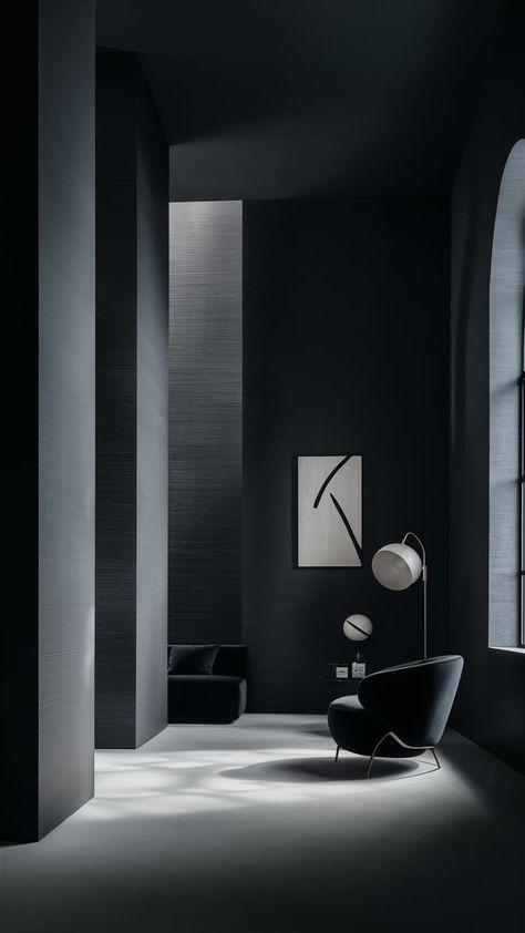 Explore the beauty of minimalism with this elegant interior scene featuring plain black wallpaper. The smooth matte finish creates a stunning backdrop, while soft, diffused lighting highlights its texture. A modern abstract art piece and a sleek black sofa enhance the tranquility of the space, complemented by natural light flowing through an oversized window. Perfect for those seeking stylish home decor inspiration. Walls With Dark Floors, Limewash Walls, Plain Black Wallpaper, Diffused Lighting, Theatre Inspiration, Dark Floors, Light Highlights, Movie Theatre, Modern Abstract Art