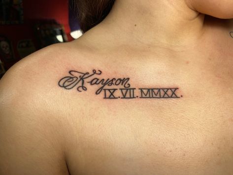 Name tattoo on chest with Roman numerals Names With Roman Numerals Tattoo, Name Tattoos With Roman Numerals, Name With Roman Numeral Tattoo, Tattoo Ideas Female Sons Name, Roman Numeral Tattoo Chest Women, Name Collarbone Tattoo, Name And Birthday Tattoos For Women, Tattoo Ideas Female Boyfriend Name, Name On Shoulder Tattoo