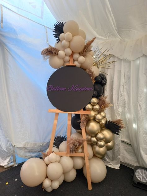 Balloon Arch With Sign, Easel Sign With Balloons, Easel With Balloon Garland, Balloon Garland On Easel, Balloons Around Easel, Balloon Easel Display, Easel Garland, Easel Balloon Garland, Welcome Sign Balloon Garland