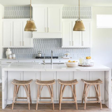 Blue glass picket backsplash tiles in a transitional kitchen surrounded by white shaker cabinets and brass pulls. Grey Kitchen Island, Blue Backsplash, White Shaker Cabinets, Wood Kitchen Island, Glass Tile Backsplash, White Marble Countertops, Arctic Blue, Kitchen Views, Coastal Kitchen