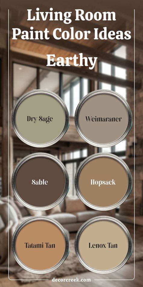 The image presents earthy living room paint color ideas with six paint swatches. The colors featured are Dry Sage, Weimaraner, Sable, Hopsack, Tatami Tan, and Lenox Tan. The background shows a cozy living room with a warm, rustic design, complementing the natural, earthy tones of the paint options. Sherwin Williams Sable, Cabin Paint Colors, Rustic Paint Colors, Tan Paint Colors, Earth Tone Living Room, Dry Sage, Warm Paint Colors, Colors For Living Room, Bedroom Revamp