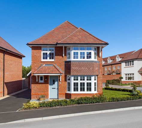 The front of a four-bedroom home. Red brick, three windows and a blue door. Homes With Character, Redrow Homes, Pebble Dash, Porch Supports, Traditional Porch, Timber Posts, Nice Homes, Doors And Floors, Hip Roof