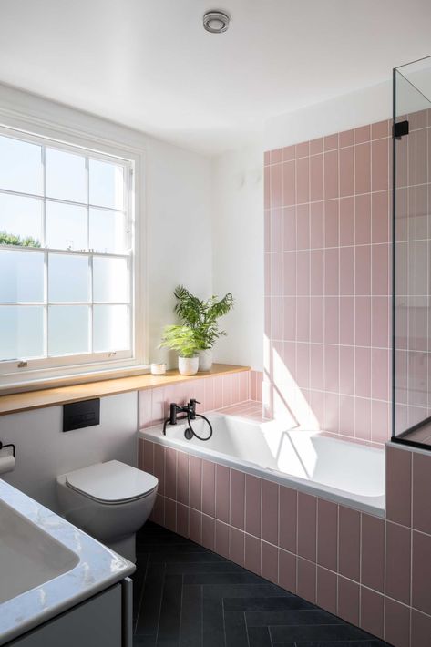 In this bathroom, pink subway tiles in a vertical layout cover the shower wall and the bathtub surround. Bradley Van Der Straeten, Pink Tile Bathroom, Retro Pink Bathroom, Terrace Home, Green Tile Bathroom, Bathtub Surround, Small Shower, Timber Shelves, Subway Tiles Bathroom