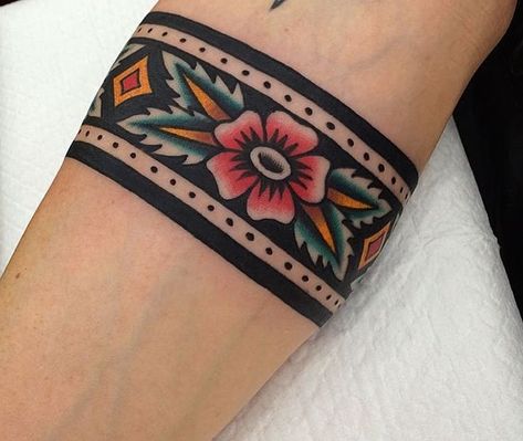 Wrist Tattoos Neo Traditional, Aztec Wrist Band Tattoo, Cover Up Arrow Tattoo, Traditional Flower Band Tattoo, American Traditional Wrist Cuff Tattoo, American Traditional Arm Band, Forearm Cuff Tattoo, Traditional Band Tattoo, Traditional Cuff Tattoo