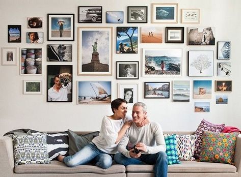 45+ Creative Living Room Wall Gallery Design Ideas #livingroom #livingroomwalldecor #livingroomwallgalleryideas Lots Of Photos On The Wall, Photo Wall Frames, Travel Photo Wall, Photowall Ideas, Gallery Wall Design, Travel Gallery Wall, Photo Wall Display, Picture Gallery Wall, Gallery Wall Layout